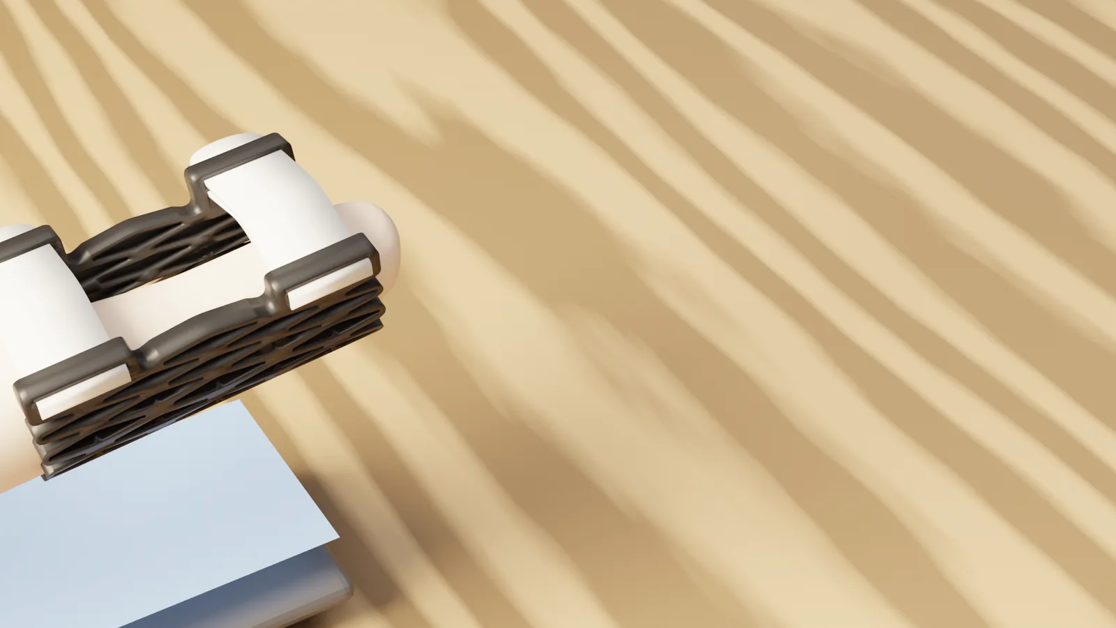 A hand wearing the Struxaform™ Full-Finger Splint, the splinted finger resting on a phone on a sunlit desk